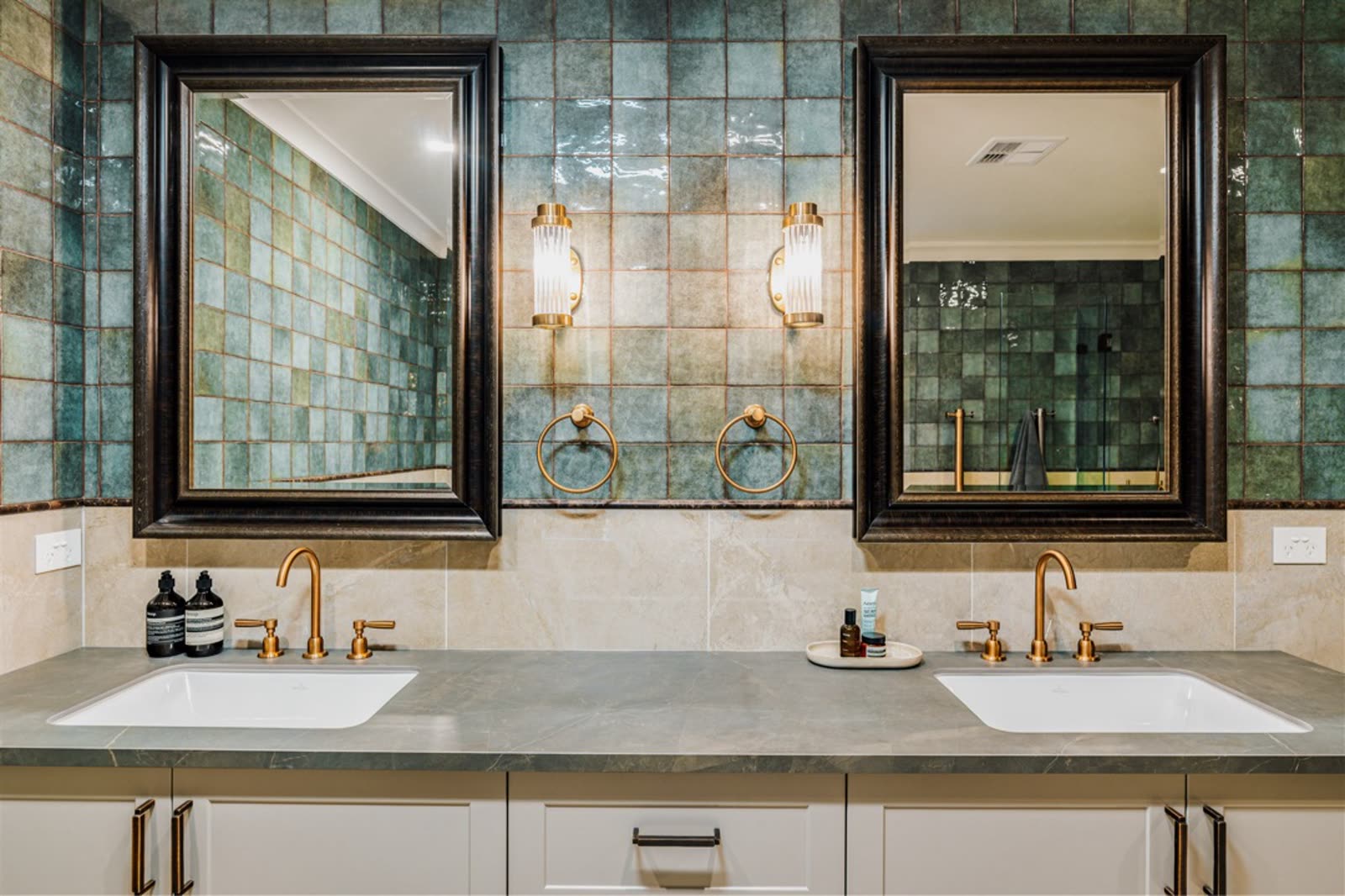 Griffith main bathroom renovation with green tile and twin black-framed mirrors