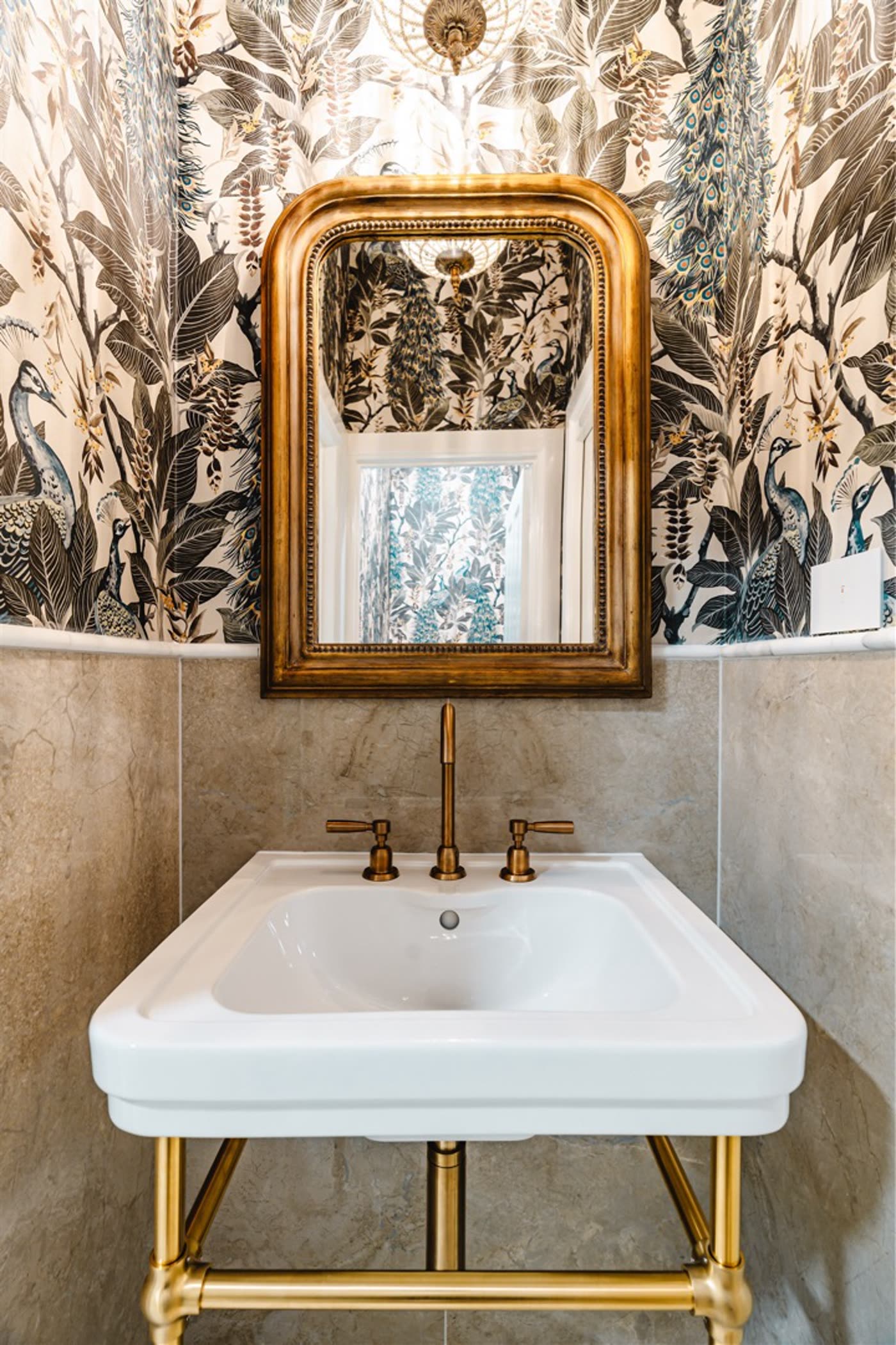 Griffith guest powder room with peacock wallpaper and brass fittings