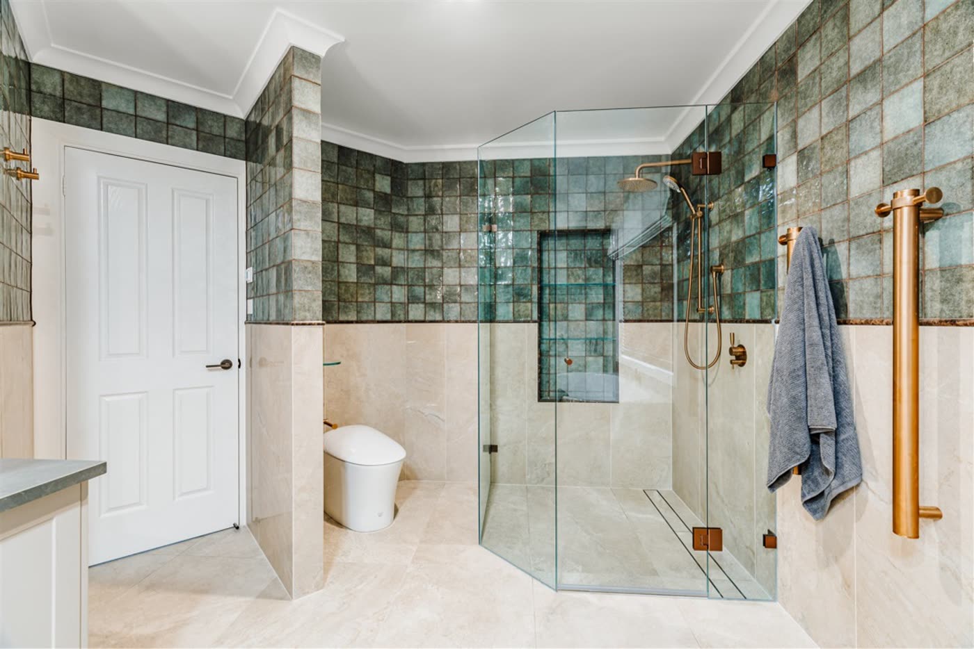 Griffith ensuite with green zellige tile feature wall and brass fittings