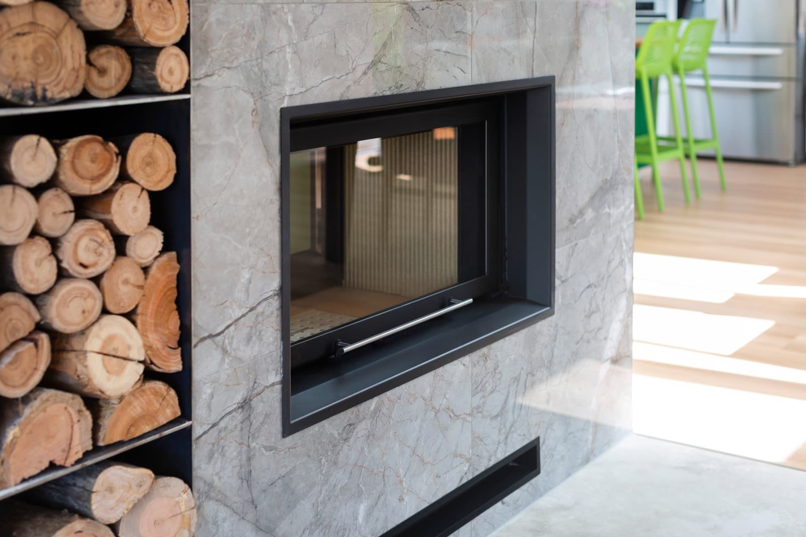 Holder fireplace detail with marble surround and timber woodstack
