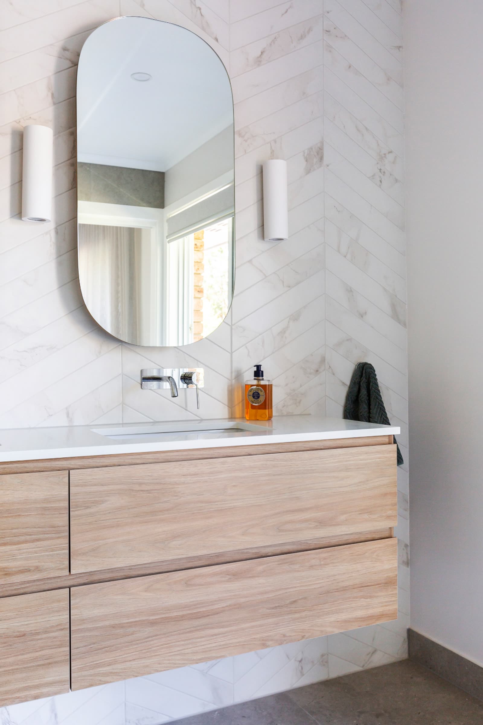 Weetangera ensuite with chevron marble feature wall and timber vanity