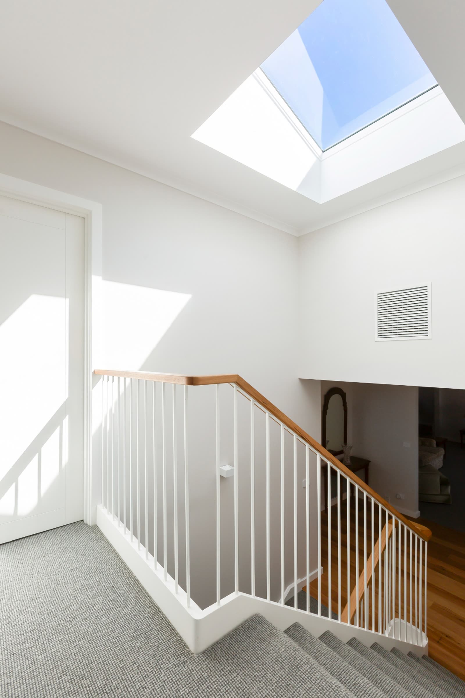 Weetangera stairwell with skylight and timber handrails